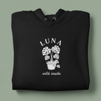 Black hoodie with front hood and eyelet drawstrings; potted palm graphic with “LUNA”.