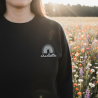 Black custom name sweatshirt with embroidered rainbow arch logo: charlotte