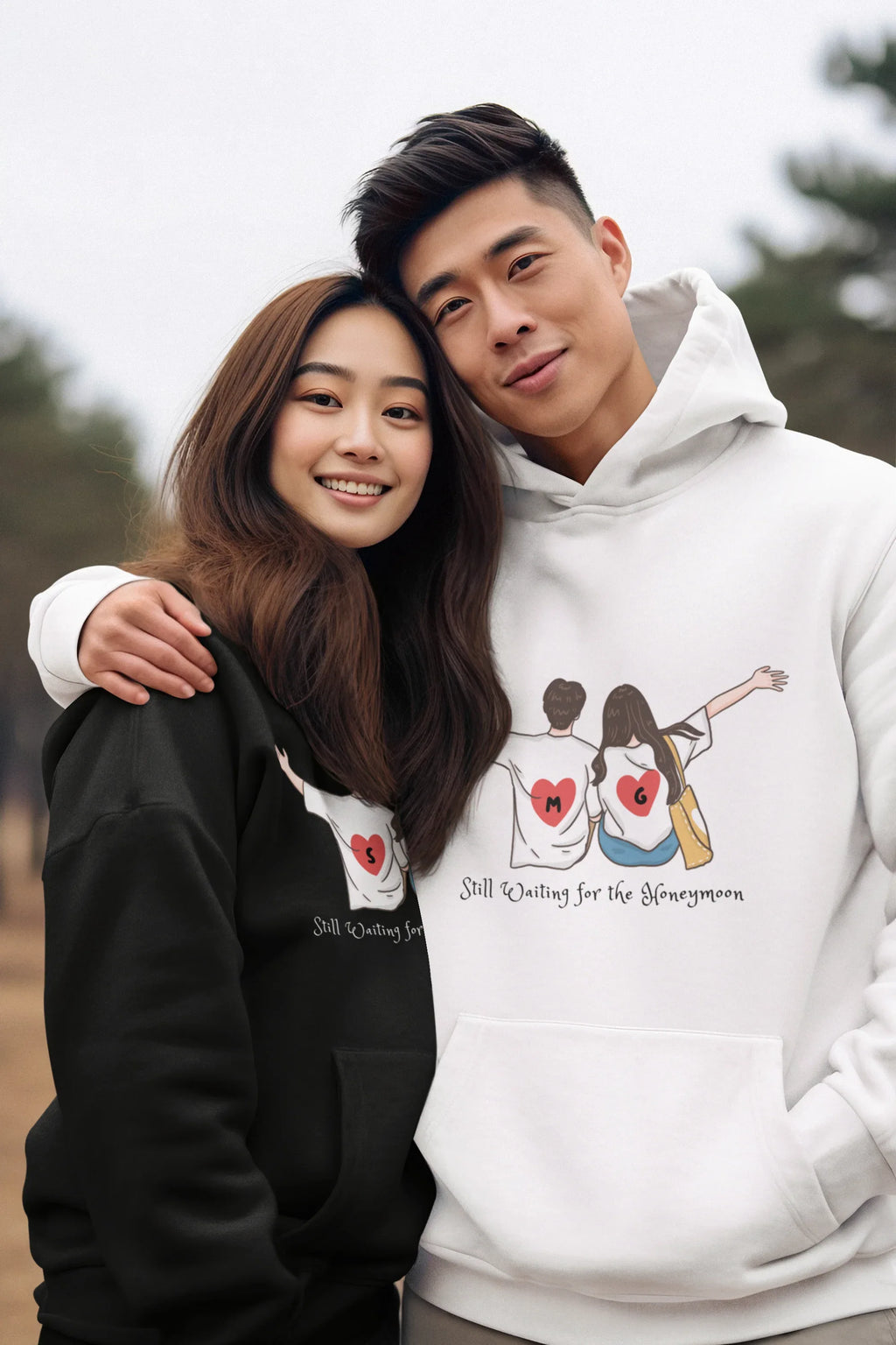 White pullover hoodie with drawstring hood and couple graphic on front