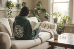 Forest green hooded sweatshirt with SAVE THE PLANET wreath graphic on back