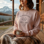 Woman on cabin porch in dusty pink sweatshirt