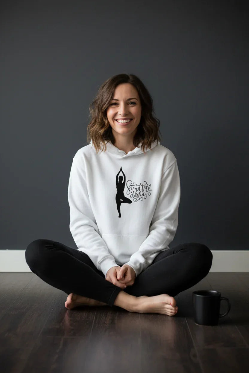White pullover hoodie with hood and dancer silhouette logo graphic, front view