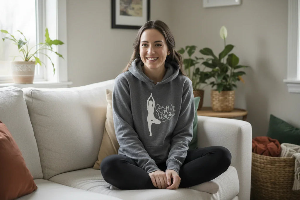 Gray pullover hoodie with hood and front pocket, featuring dancer silhouette logo graphic