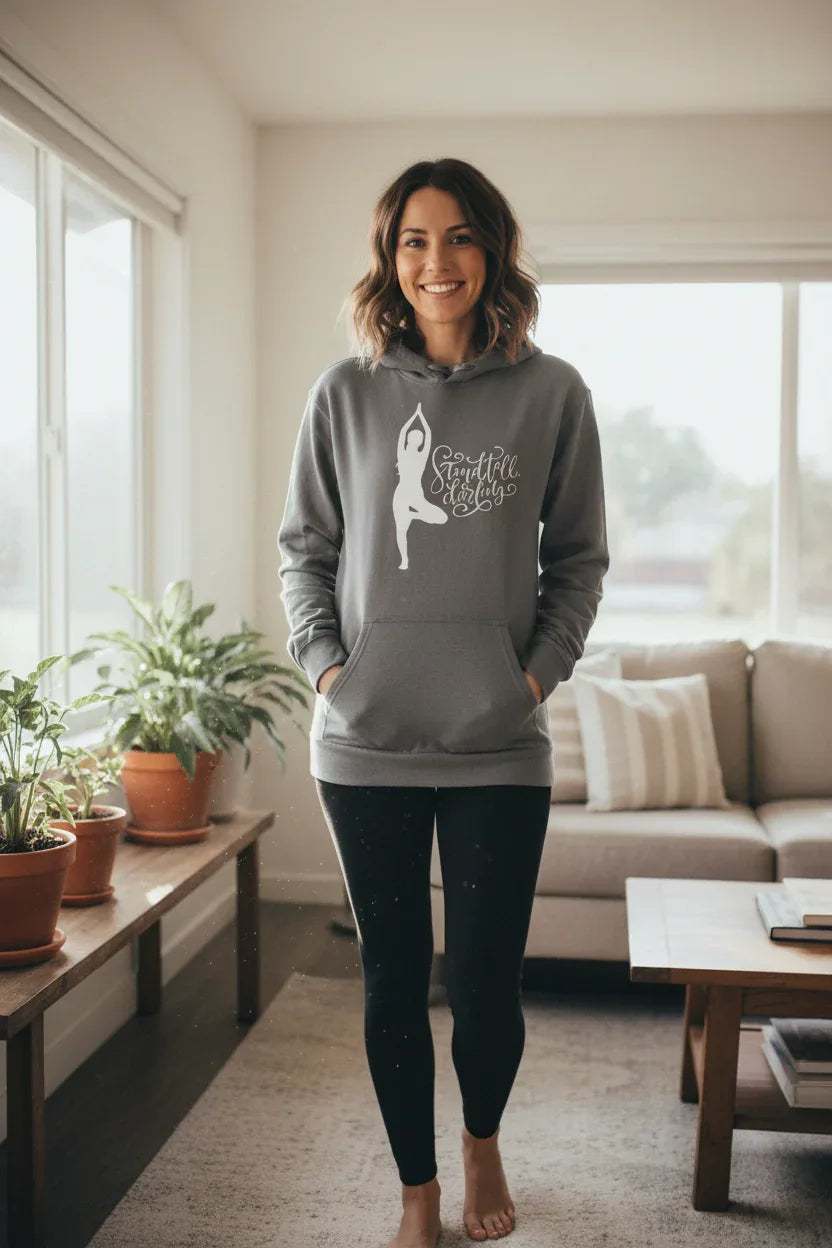 Gray pullover hoodie with hood and front pocket, dancer silhouette graphic on chest