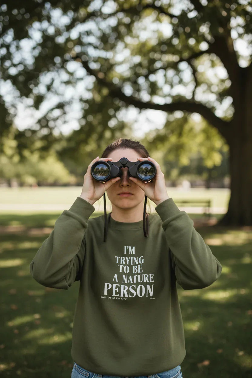 Military green sweatshirt with 'I'm Trying to Be a Nature Person' slogan