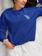 Royal blue sweatshirt with crew neck and small palm-branch graphic on the chest