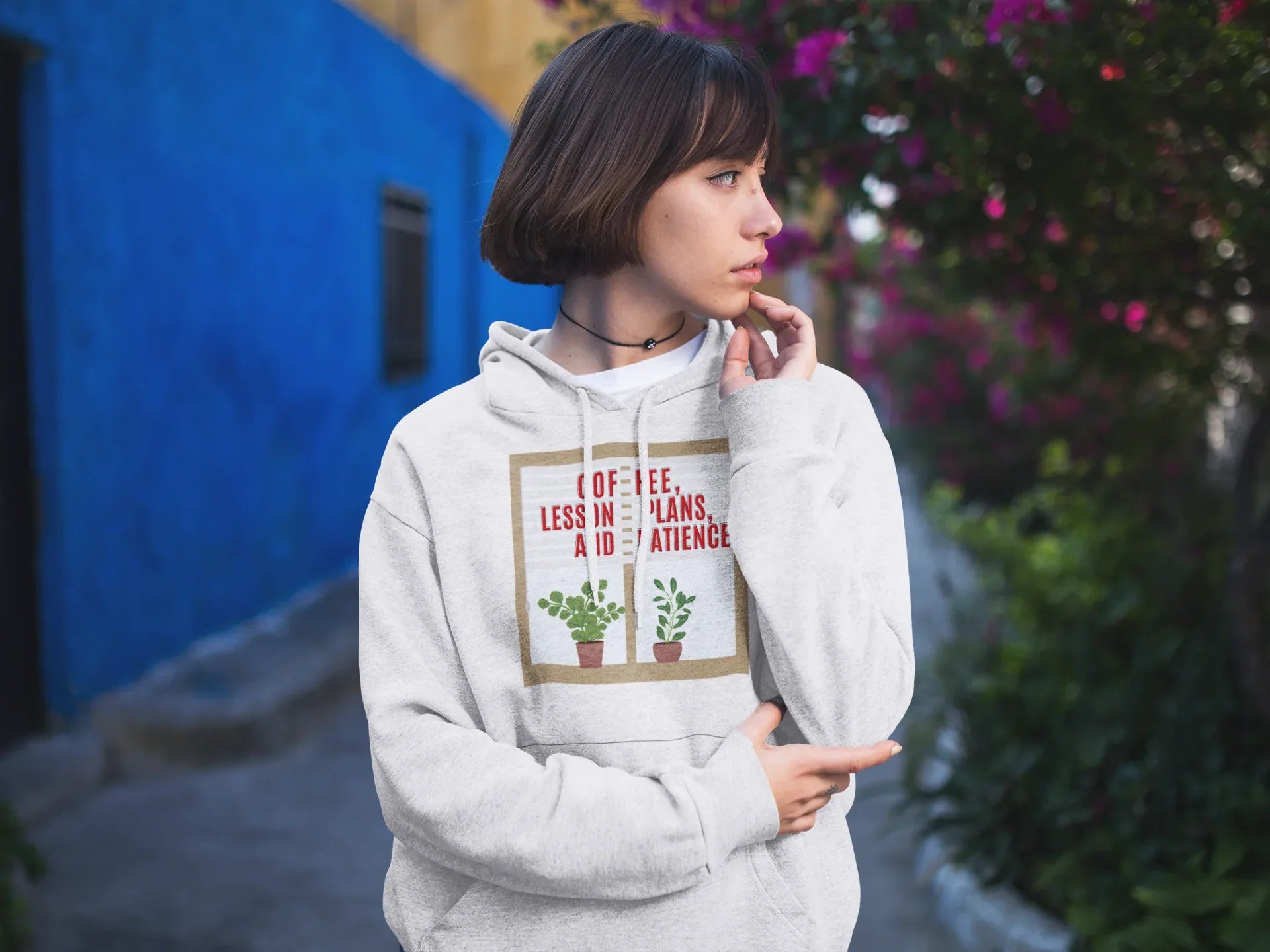 Light gray pullover hoodie with hood and pouch pocket, featuring a coffee-themed graphic on chest