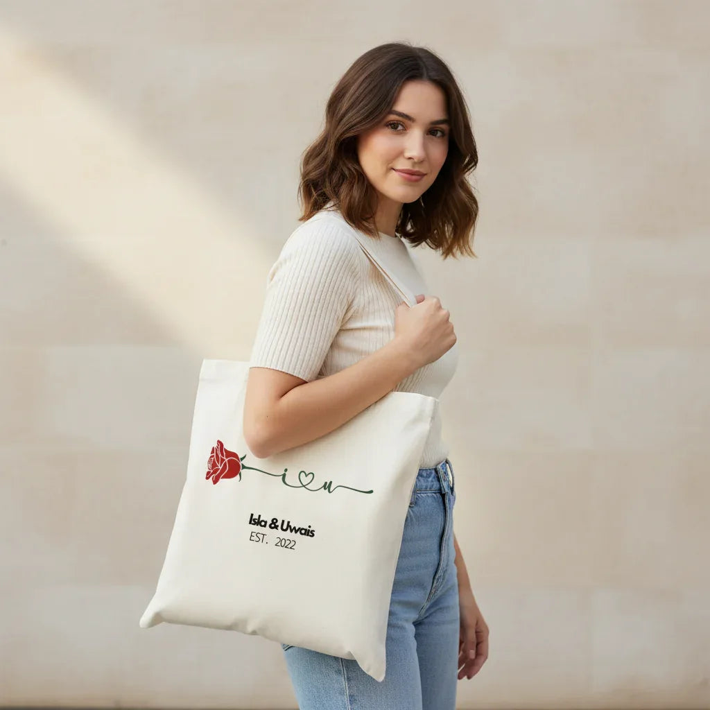White tote bag with red rose emblem and custom name/date print