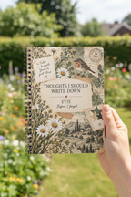 Zoomed-in UGC mockup of the Evie notebook in a garden
