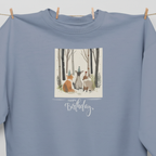 Light blue sweatshirt front close-up with woodland animals Happy Birthday print and crew neck